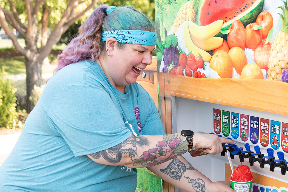 happy woman getting shave ice at food truck rally